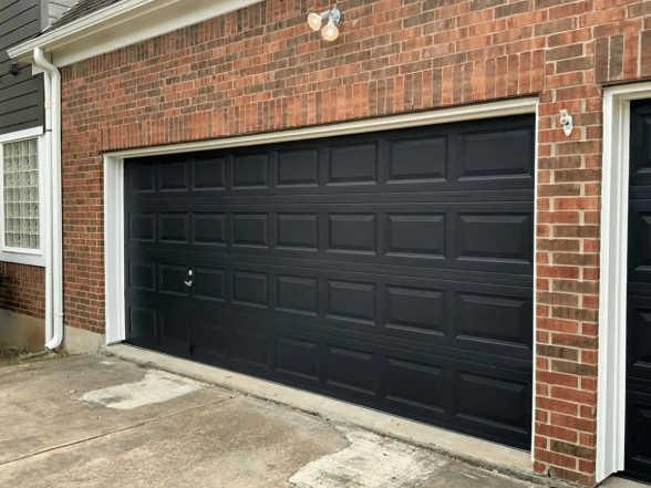 Black Garage Doors on a Red Brick House
