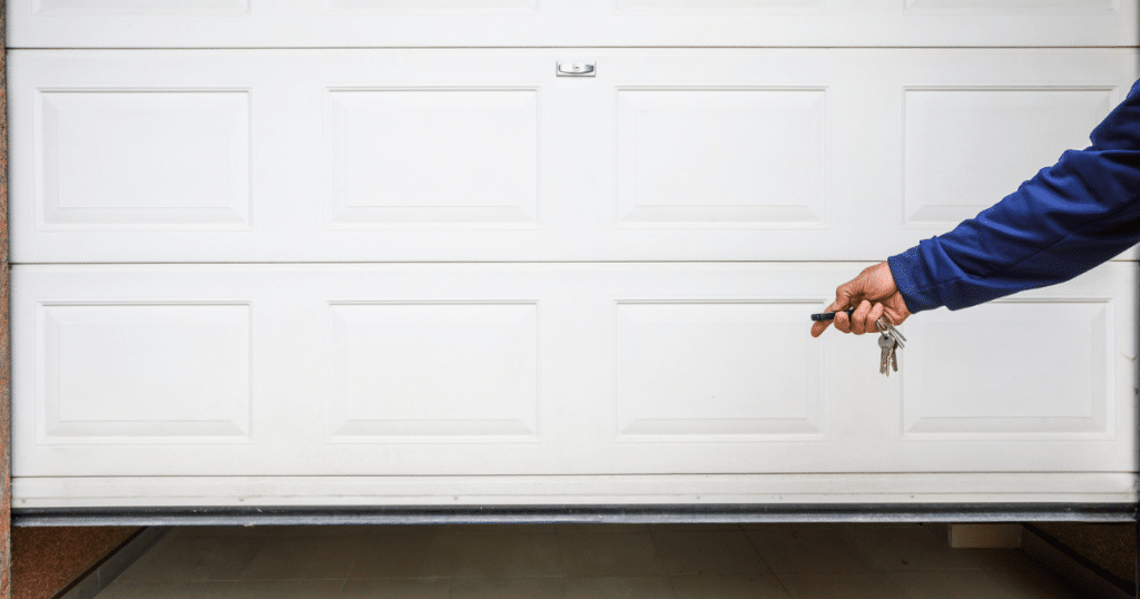 Hand holding remote for garage door